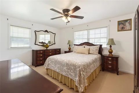 a bedroom with bed and window