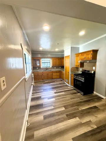 a kitchen with stainless steel appliances granite countertop a stove and a refrigerator