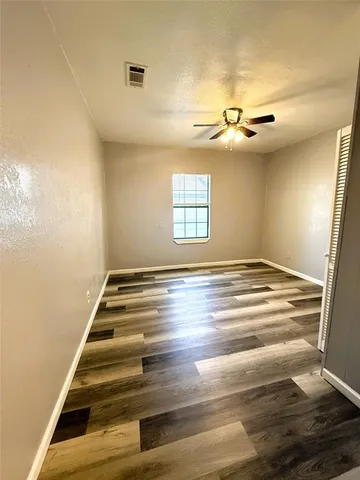 an empty room with wooden floor