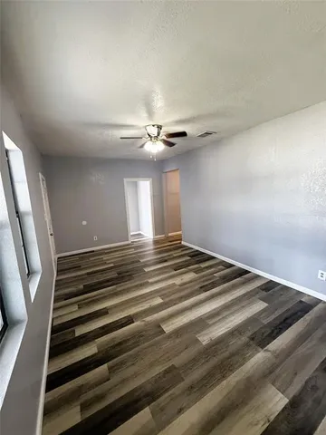 a view of a livingroom with a ceiling fan and window