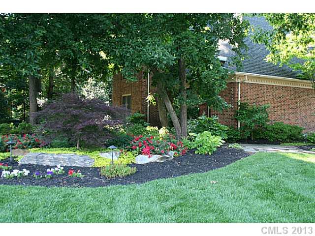 245 South Downs Way, Unit 49 Fort Mill, SC 29708 - Photo 14 of 16 a view of a garden with flowers and a bench