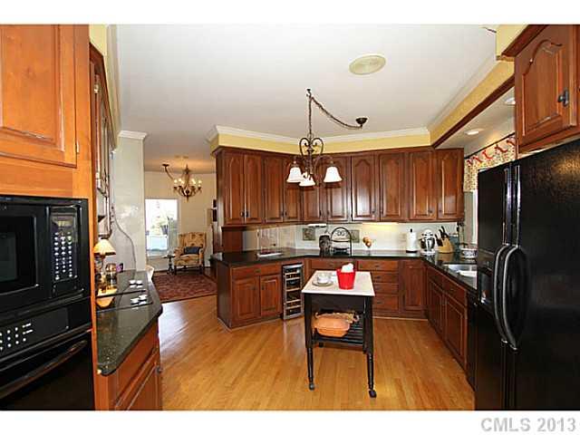245 South Downs Way, Unit 49 Fort Mill, SC 29708 - Photo 4 of 16 a open kitchen with refrigerator stove and wooden floor