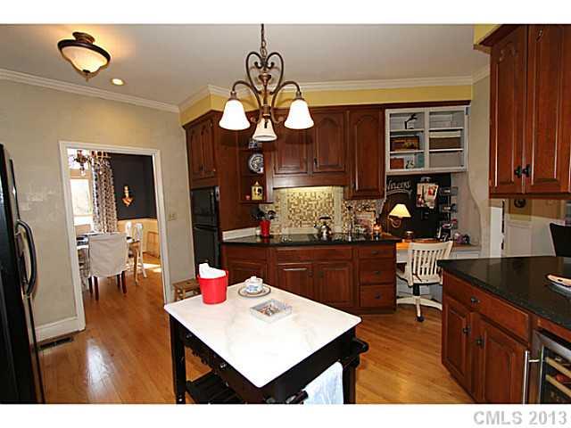 245 South Downs Way, Unit 49 Fort Mill, SC 29708 - Photo 5 of 16 a kitchen area with granite countertop a sink cabinets and stainless steel appliances