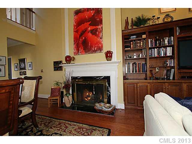 245 South Downs Way, Unit 49 Fort Mill, SC 29708 - Photo 6 of 16 a living room with furniture a fireplace and a book shelf