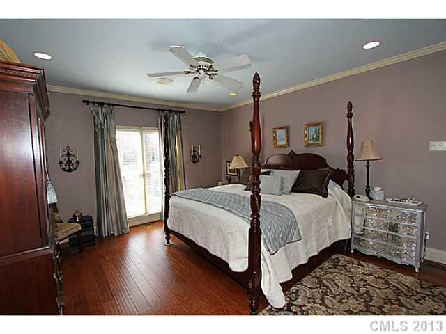 245 South Downs Way, Unit 49 Fort Mill, SC 29708 - Photo 9 of 16 a bedroom with a bed and a chandelier