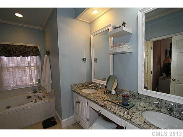 245 South Downs Way, Unit 49 Fort Mill, SC 29708 - Photo 10 of 16 a bathroom with a granite countertop sink a mirror and shower