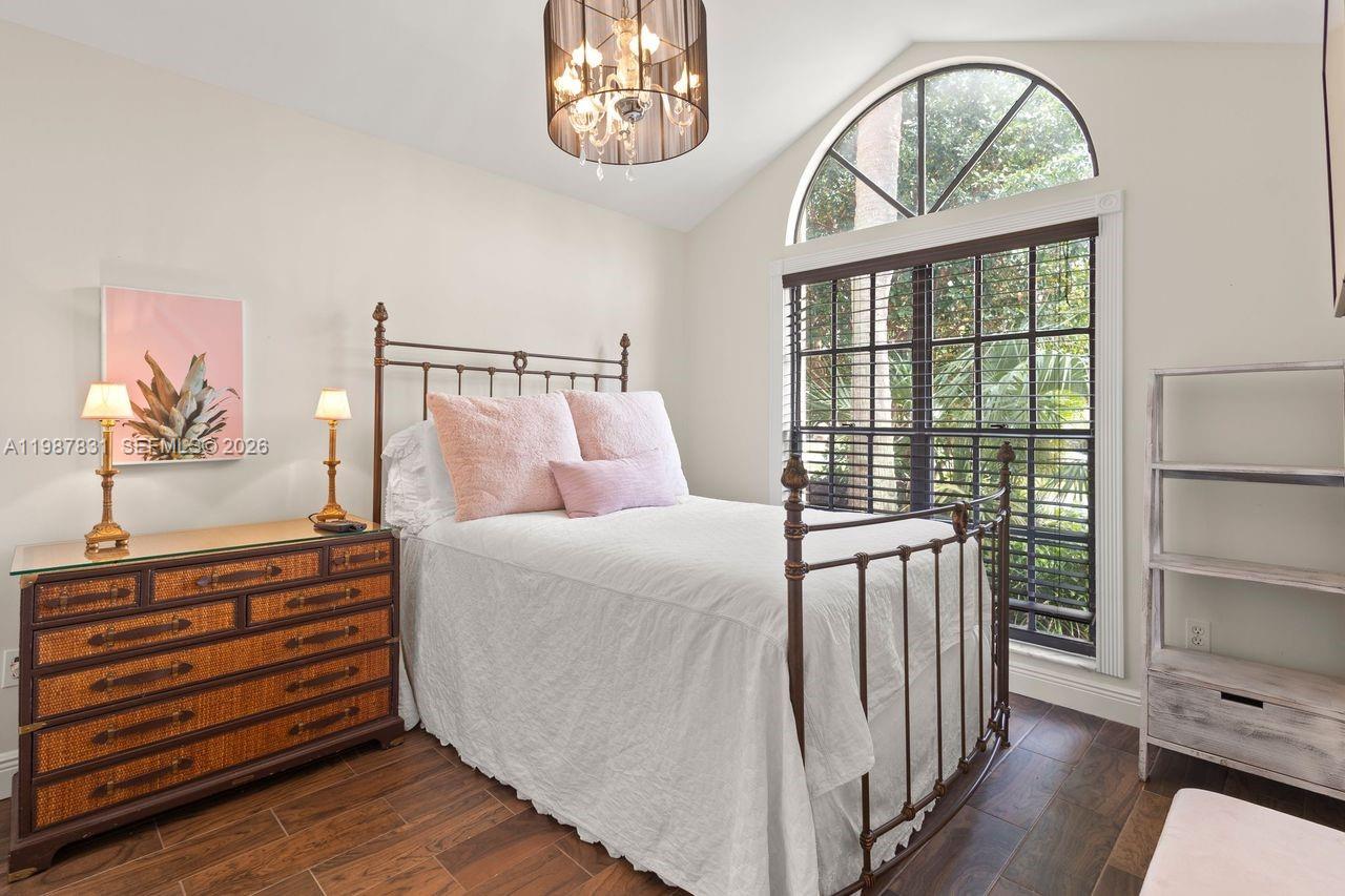 18551 Woodstream Drive Boca Raton, FL 33498 - Photo 12 of 27 a bedroom with a bed and a window