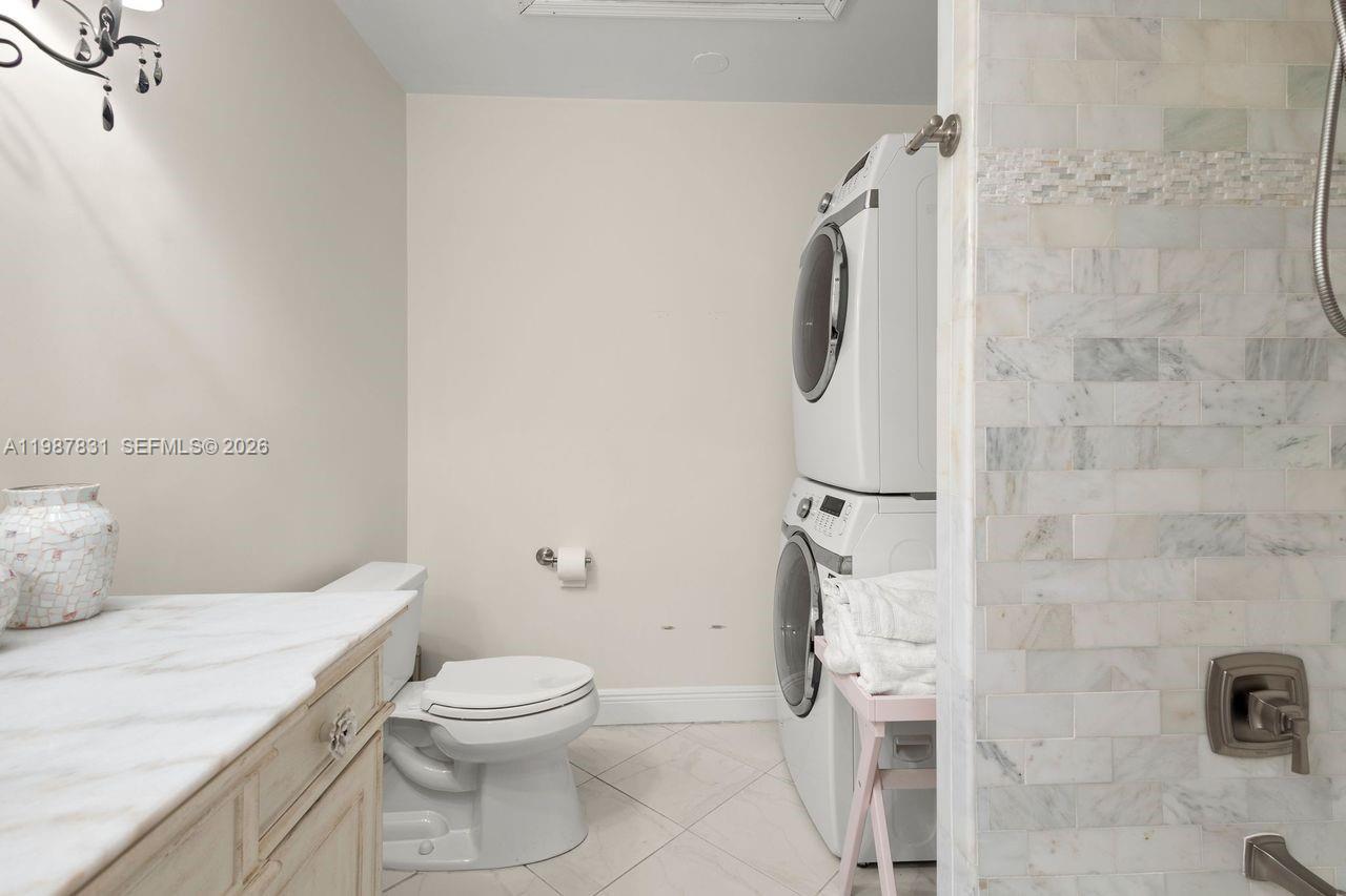 18551 Woodstream Drive Boca Raton, FL 33498 - Photo 13 of 27 a bathroom with a granite countertop toilet and a shower