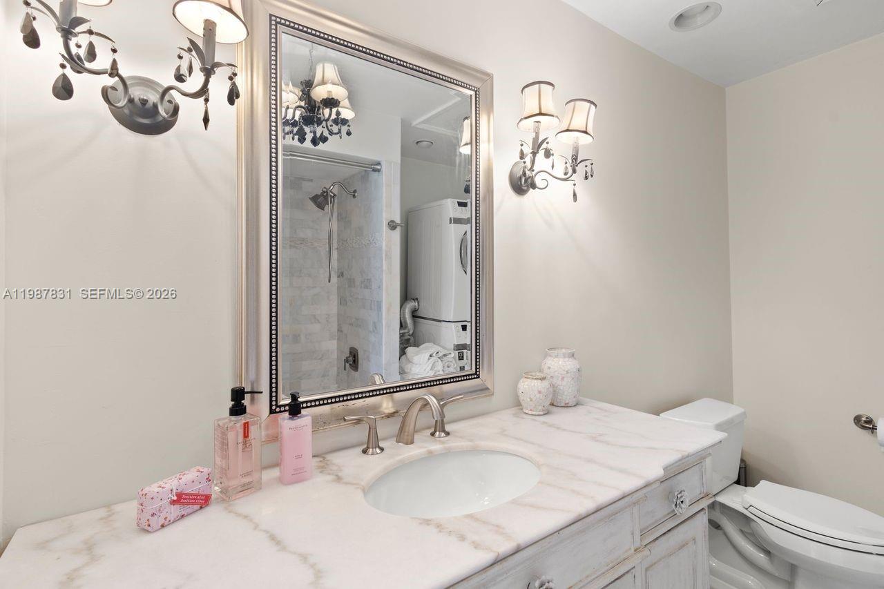 18551 Woodstream Drive Boca Raton, FL 33498 - Photo 14 of 27 a bathroom with a sink vanity mirror and toilet