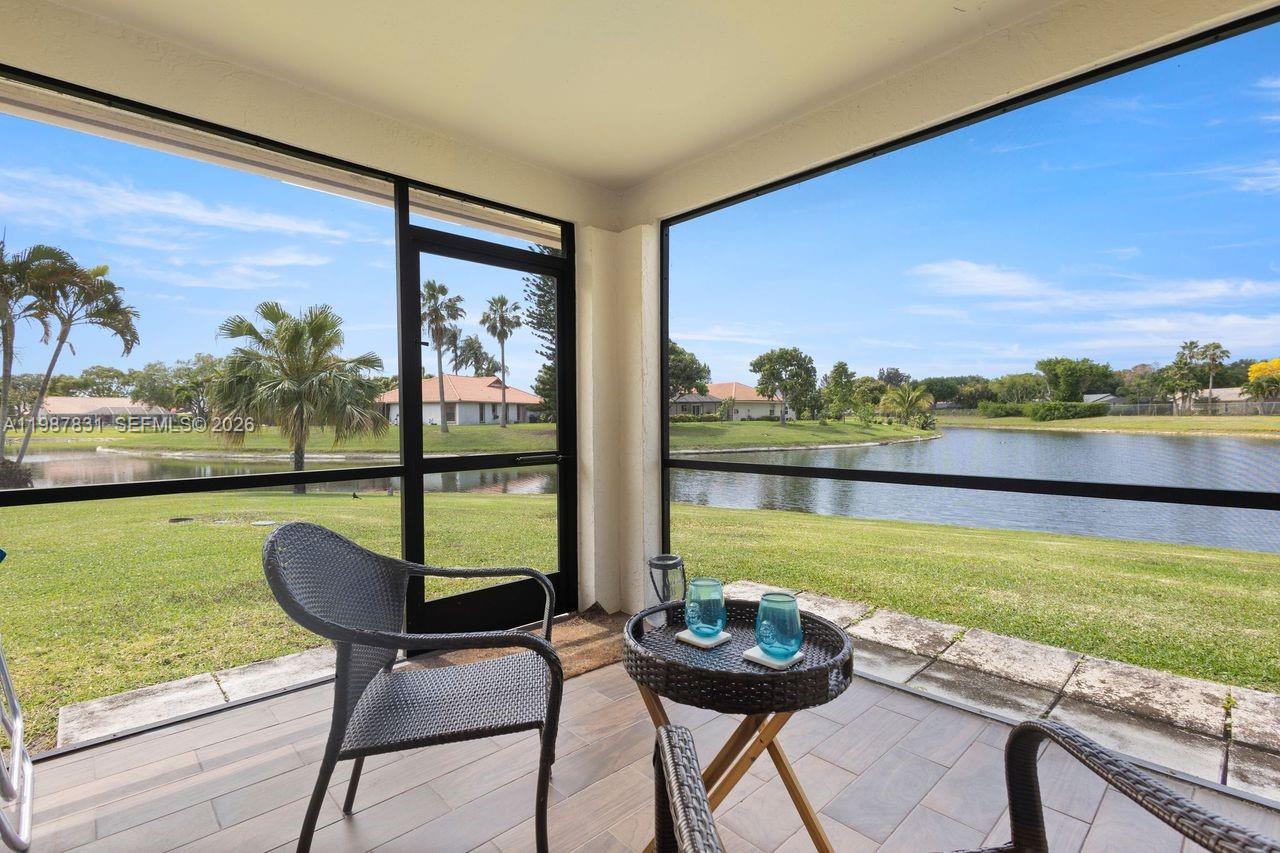 18551 Woodstream Drive Boca Raton, FL 33498 - Photo 15 of 27 a view of a city from a dining room with large windows