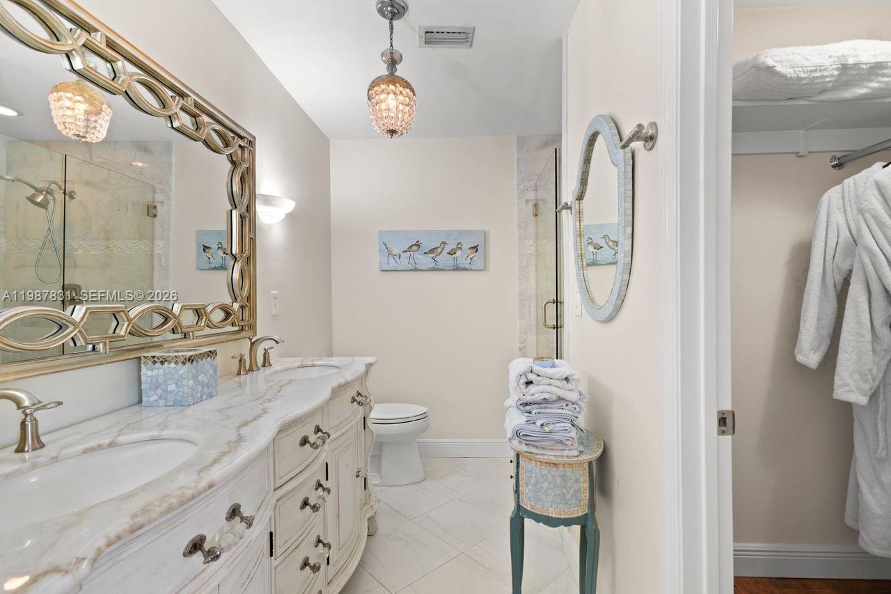 18551 Woodstream Drive Boca Raton, FL 33498 - Photo 20 of 27 a bathroom with a granite countertop sink toilet and shower