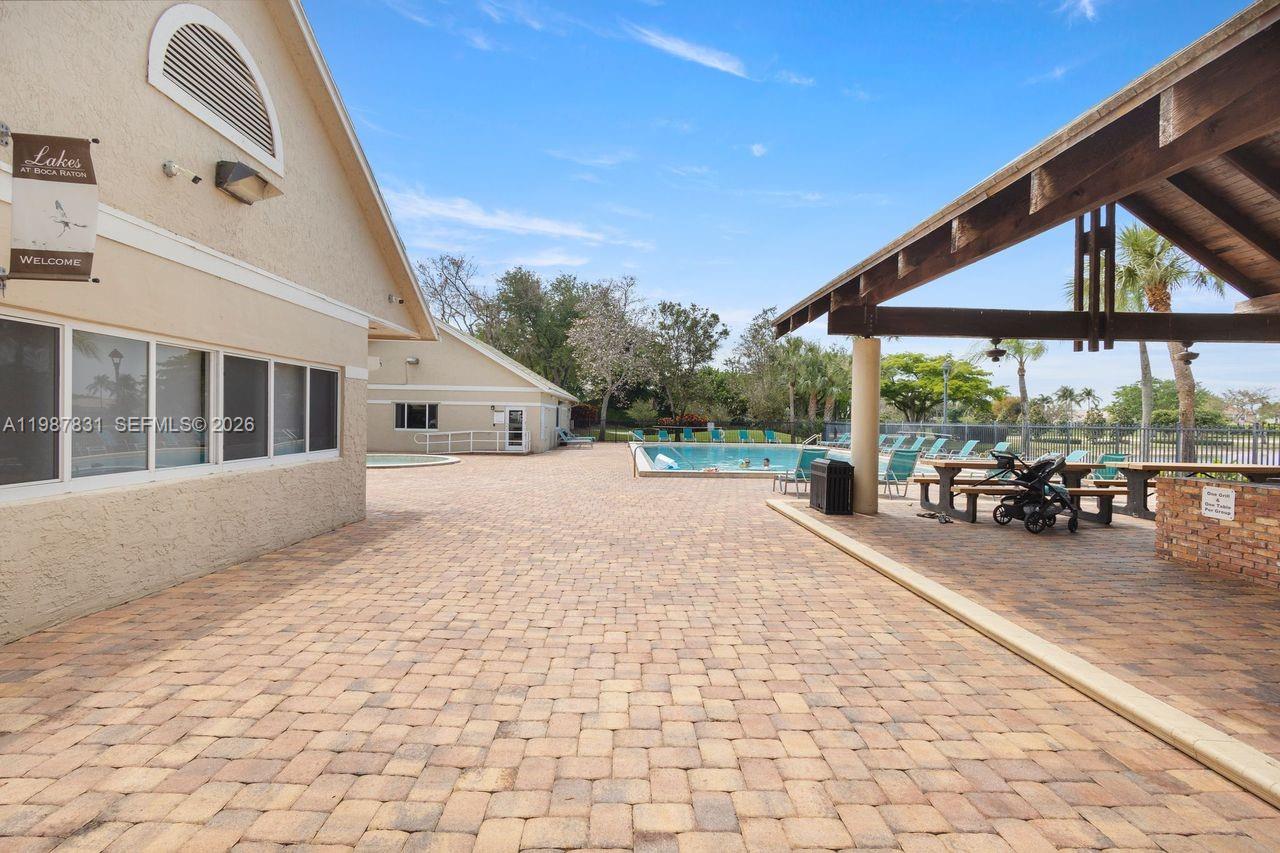 18551 Woodstream Drive Boca Raton, FL 33498 - Photo 25 of 27 a view of house with backyard and sitting area