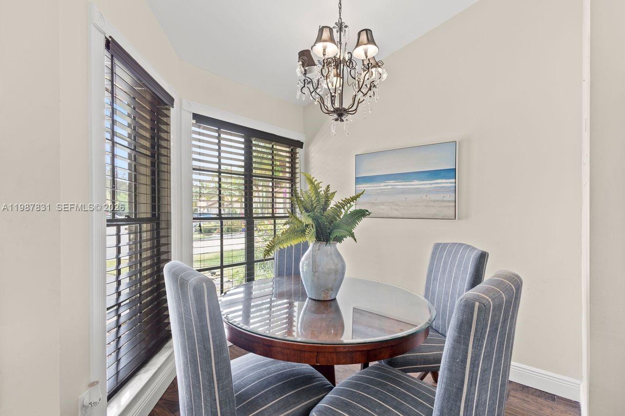 18551 Woodstream Drive Boca Raton, FL 33498 - Photo 4 of 27 a view of a dining room with furniture window and outside view