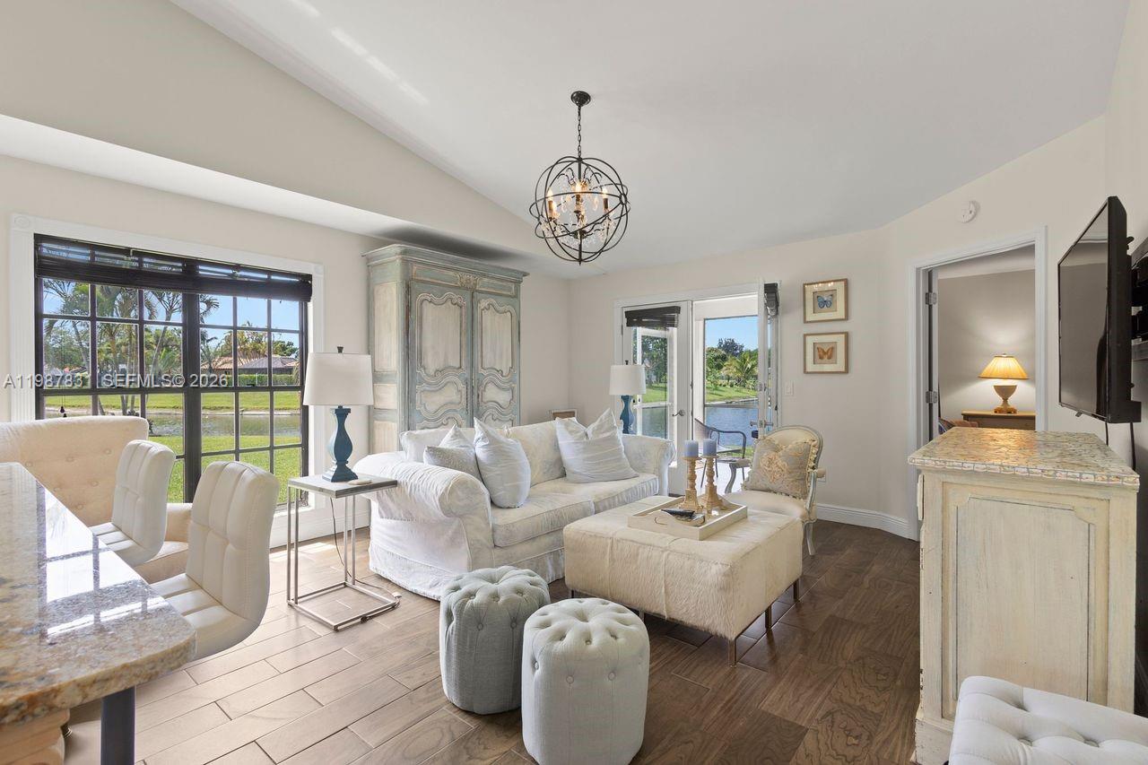 18551 Woodstream Drive Boca Raton, FL 33498 - Photo 9 of 27 a living room with furniture and a floor to ceiling window