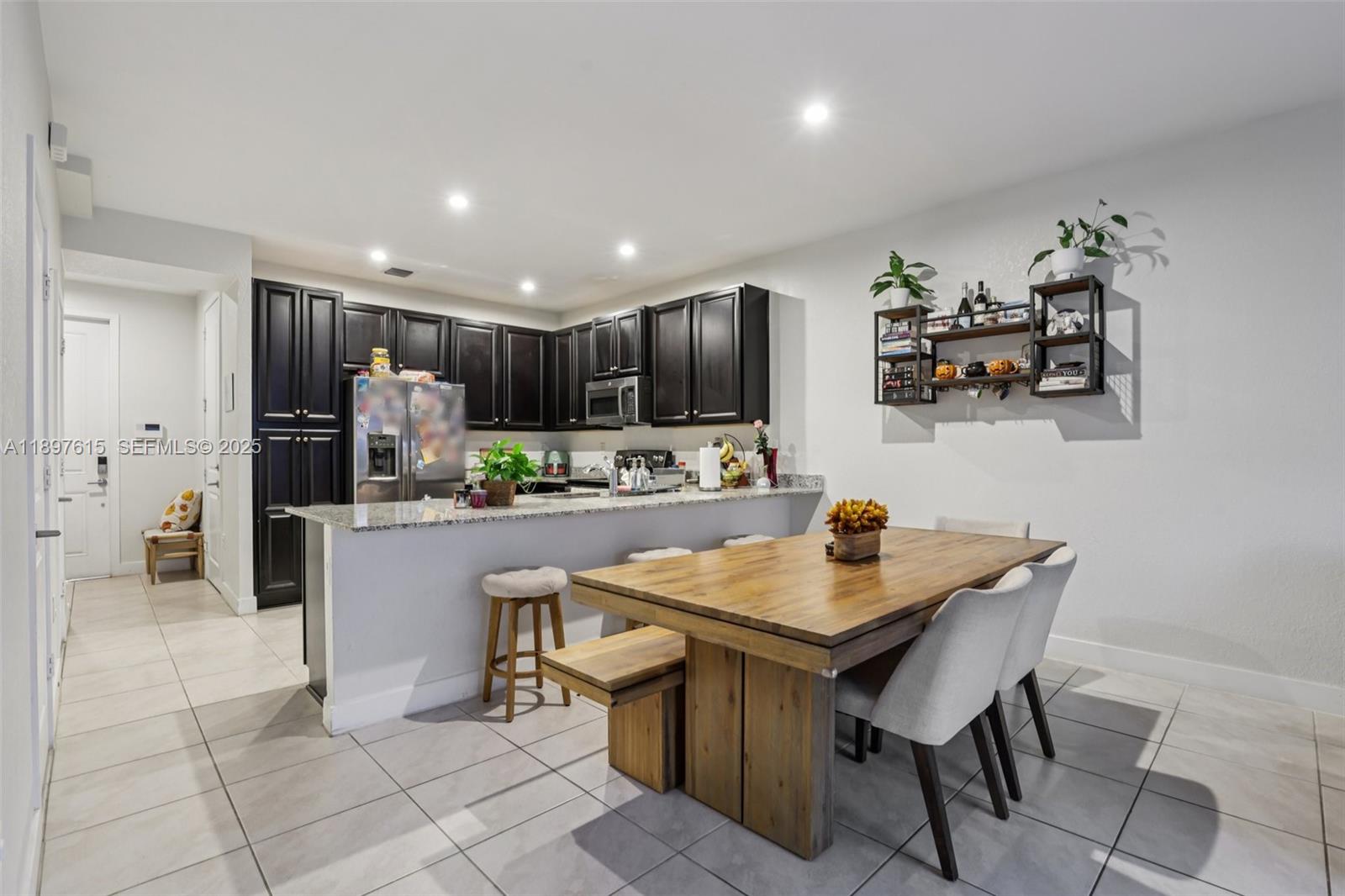 23291 Southwest 110th Court Homestead, FL 33032 - Photo 11 of 41 a kitchen with stainless steel appliances granite countertop a stove a sink a refrigerator and a refrigerator