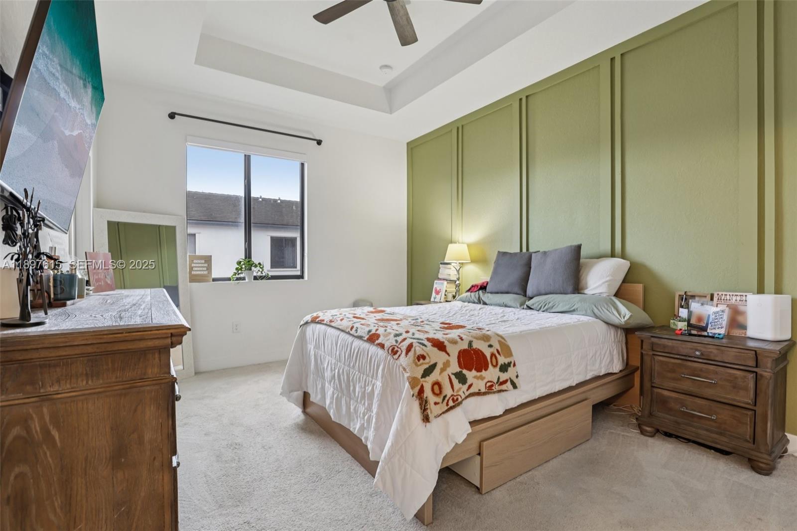 23291 Southwest 110th Court Homestead, FL 33032 - Photo 16 of 41 a bedroom with a bed and a chandelier