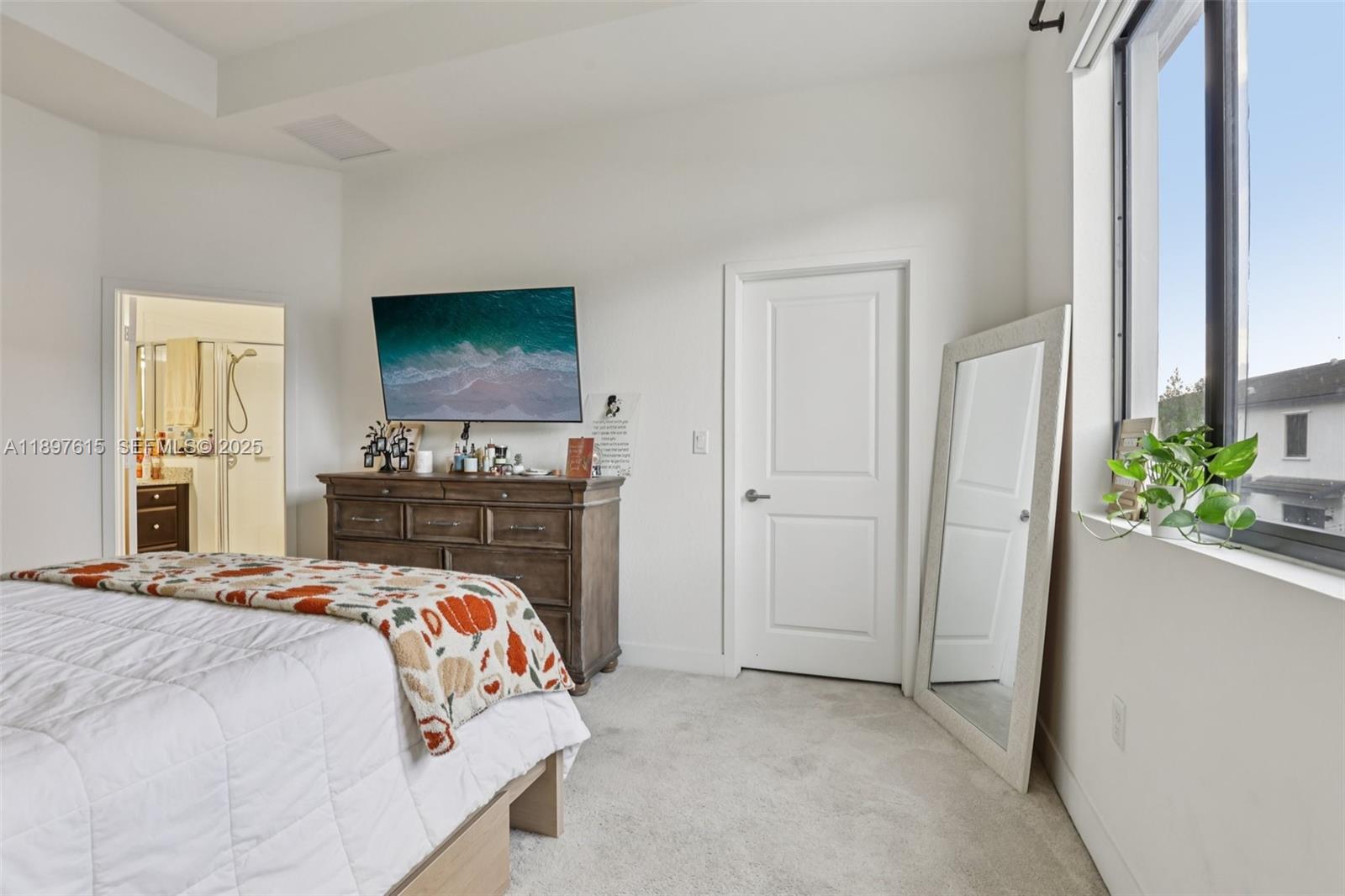 23291 Southwest 110th Court Homestead, FL 33032 - Photo 19 of 41 a bedroom with a bed and a potted plant