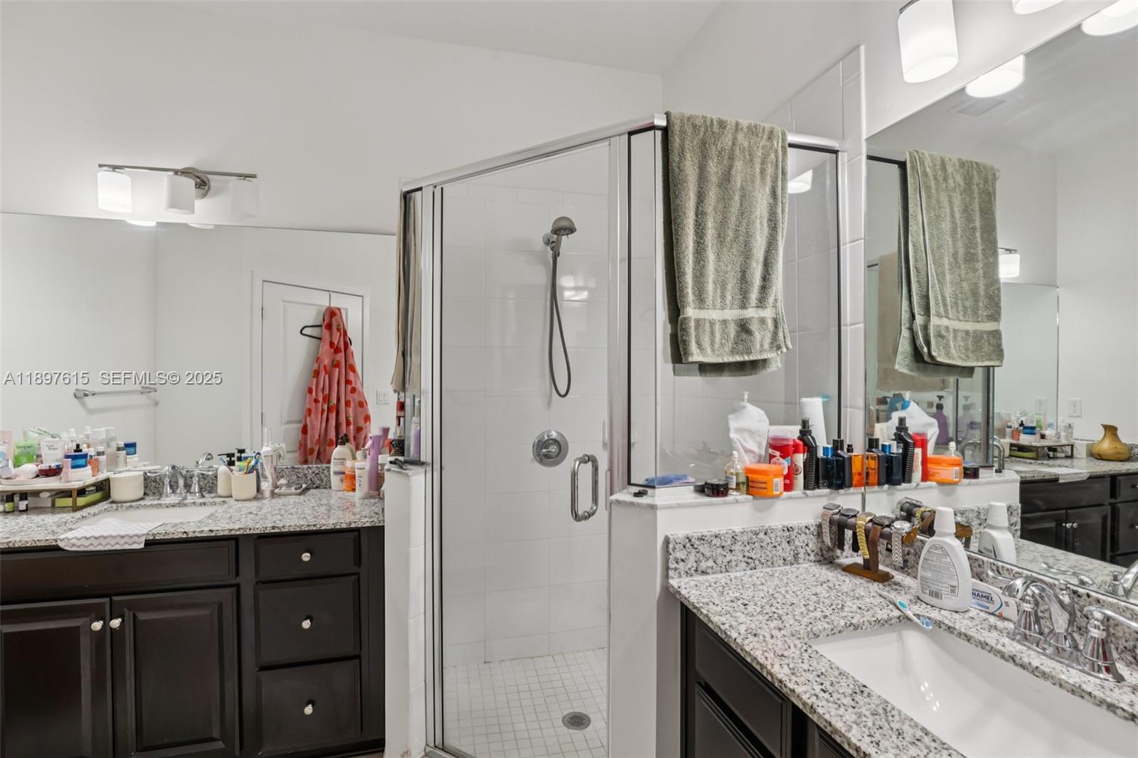 23291 Southwest 110th Court Homestead, FL 33032 - Photo 20 of 41 a bathroom with double vanity sinks a vanity two mirror and shower