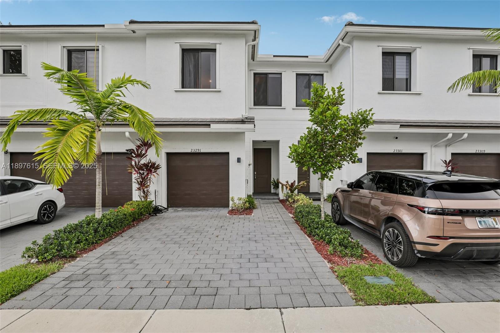 23291 Southwest 110th Court Homestead, FL 33032 - Photo 2 of 41 a front view of a house with a garden