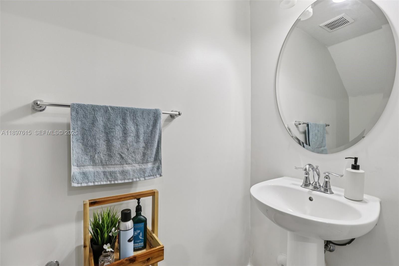 23291 Southwest 110th Court Homestead, FL 33032 - Photo 25 of 41 a bathroom with a sink and a mirror