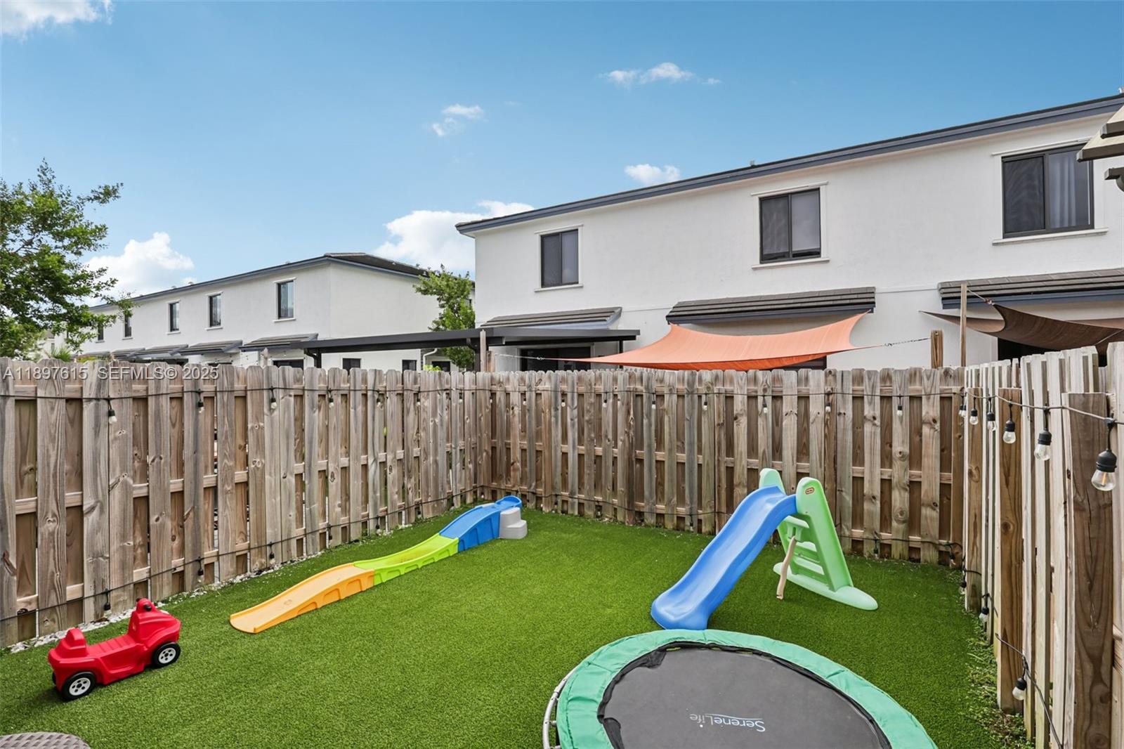 23291 Southwest 110th Court Homestead, FL 33032 - Photo 40 of 41 a childrens park with large trees and a wooden fence