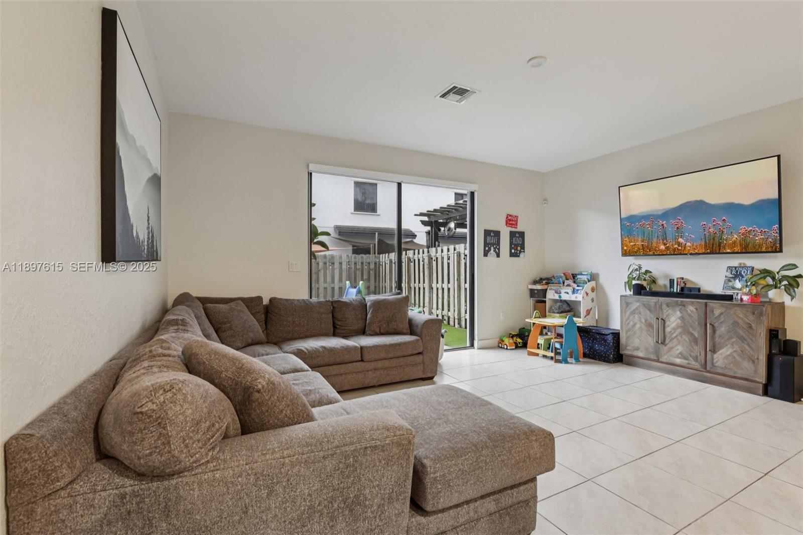 23291 Southwest 110th Court Homestead, FL 33032 - Photo 6 of 41 a living room with furniture and a flat screen tv