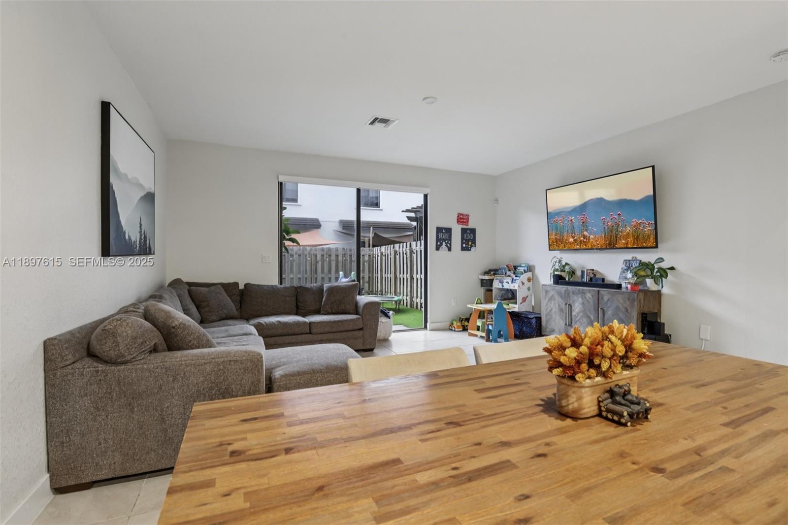 23291 Southwest 110th Court Homestead, FL 33032 - Photo 7 of 41 a living room with furniture flowerpot and a flat screen tv