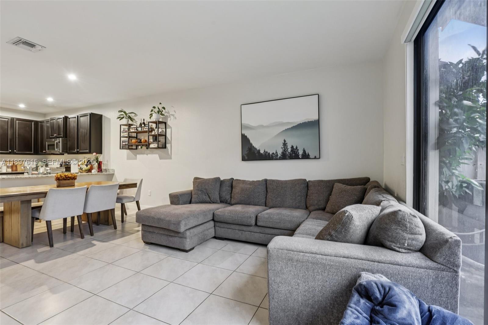 23291 Southwest 110th Court Homestead, FL 33032 - Photo 8 of 41 a living room with furniture and a dining table with kitchen view