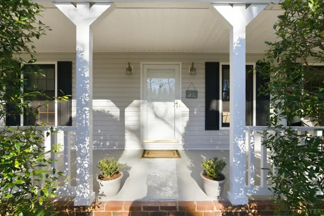a view of a patio with table and chairs potted plants