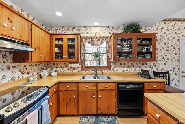 a kitchen that has a sink and a stove