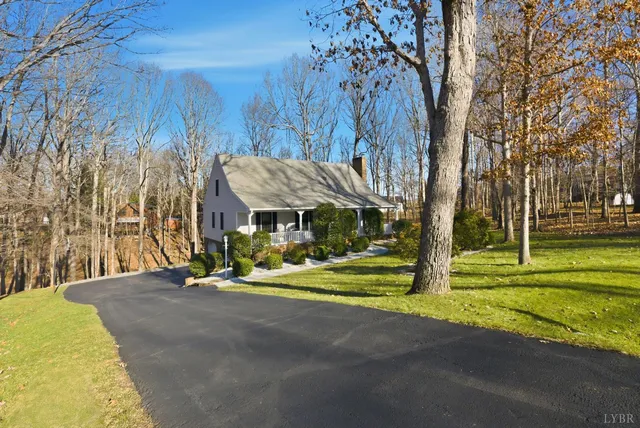 a view of backyard with table and chairs and a yard