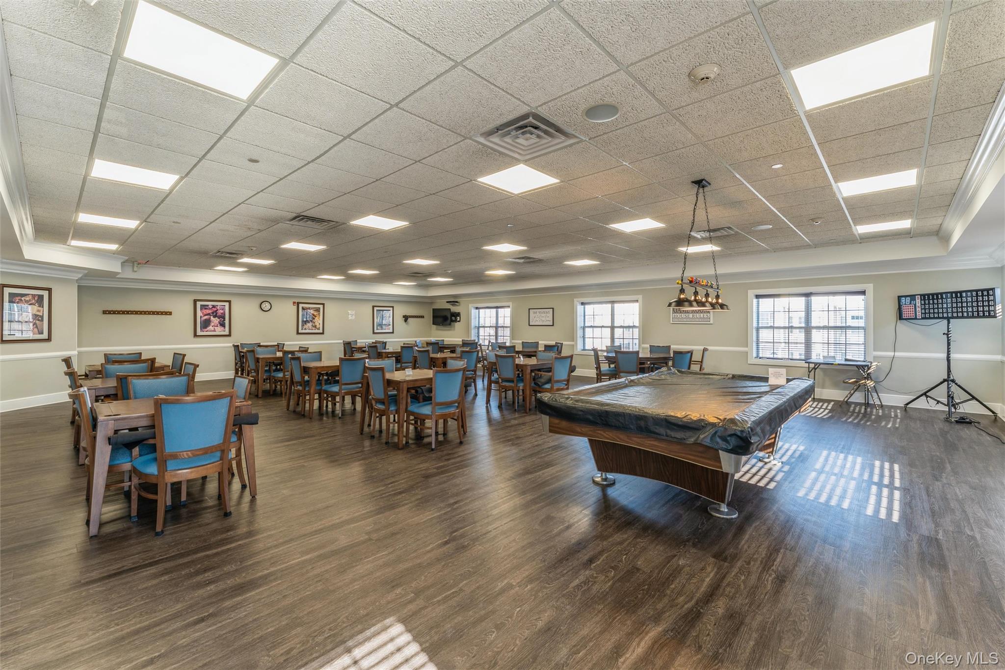 169 Spring Drive East Meadow, NY 11554 - Photo 23 of 33 a room with lots of furniture and wooden floors