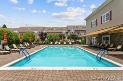 169 Spring Drive East Meadow, NY 11554 - Photo 32 of 33 a swimming pool with outdoor seating and yard
