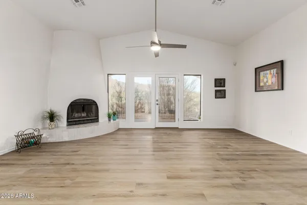 an aerial view of residential houses with outdoor space and trees