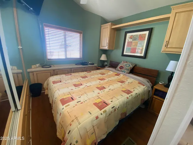 a bed sitting in a bedroom next to a window