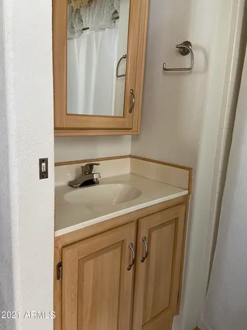 a bathroom with a sink and a mirror