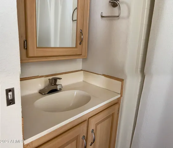 a bathroom with a sink and a mirror