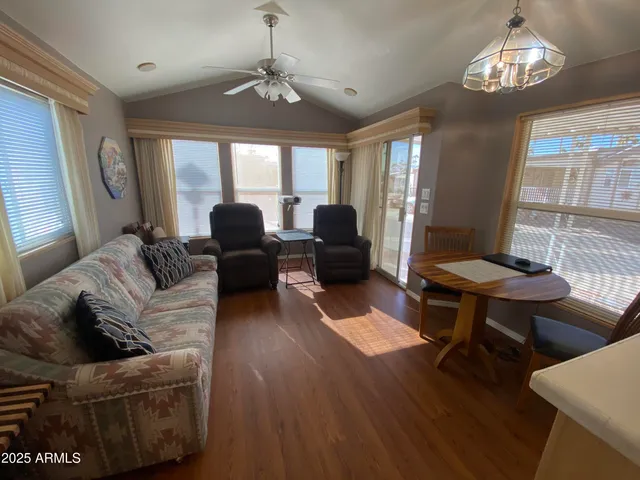 a living room with furniture chandelier and a window
