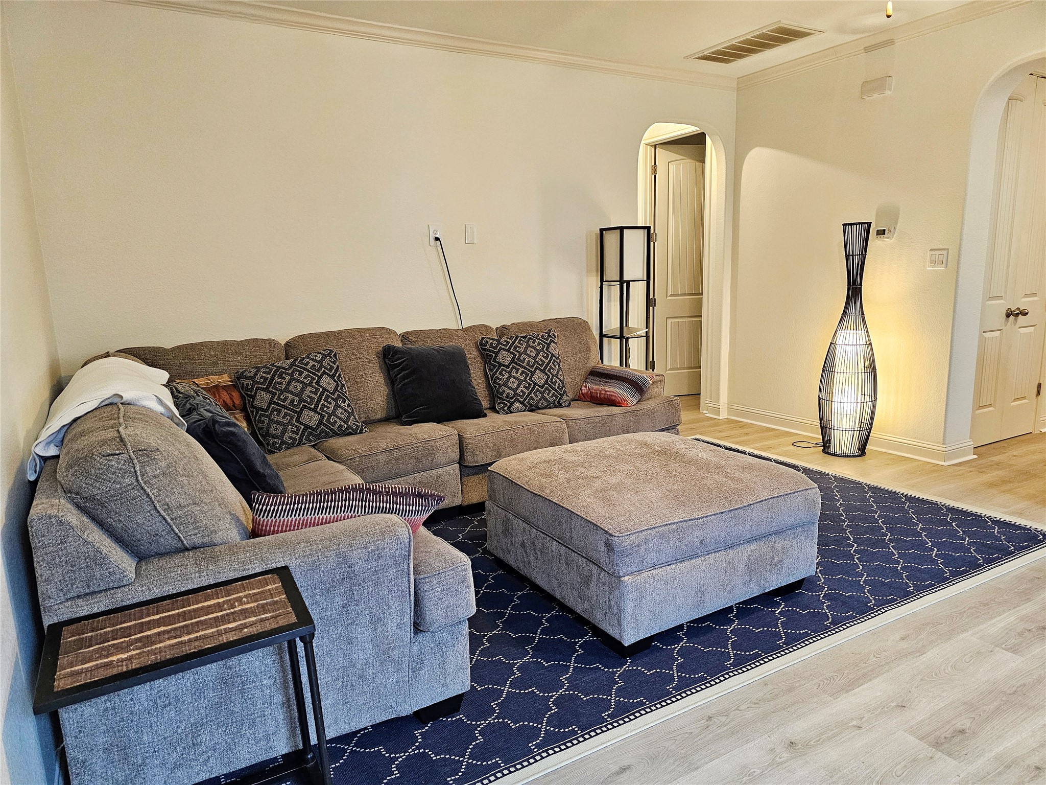 11508 Flushwing Drive Austin, TX 78754 - Photo 5 of 24 Living room with wood finished floors, arched walkways, and crown molding