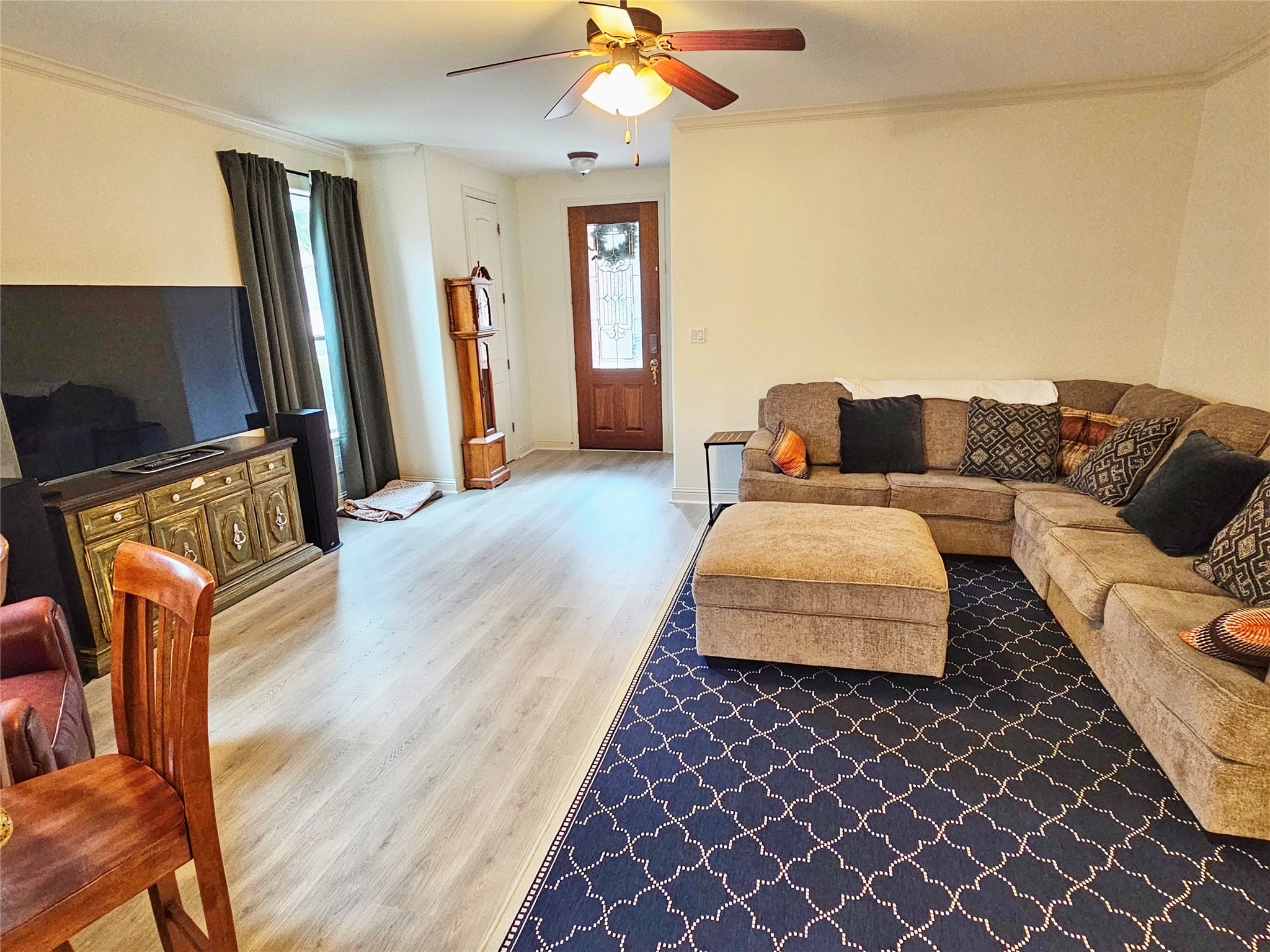 11508 Flushwing Drive Austin, TX 78754 - Photo 6 of 24 Living room with crown molding, light wood-type flooring, and a ceiling fan