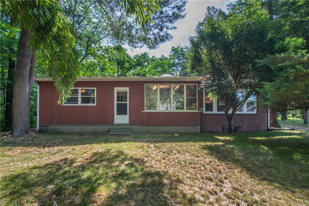a view of an house with backyard space and balcony