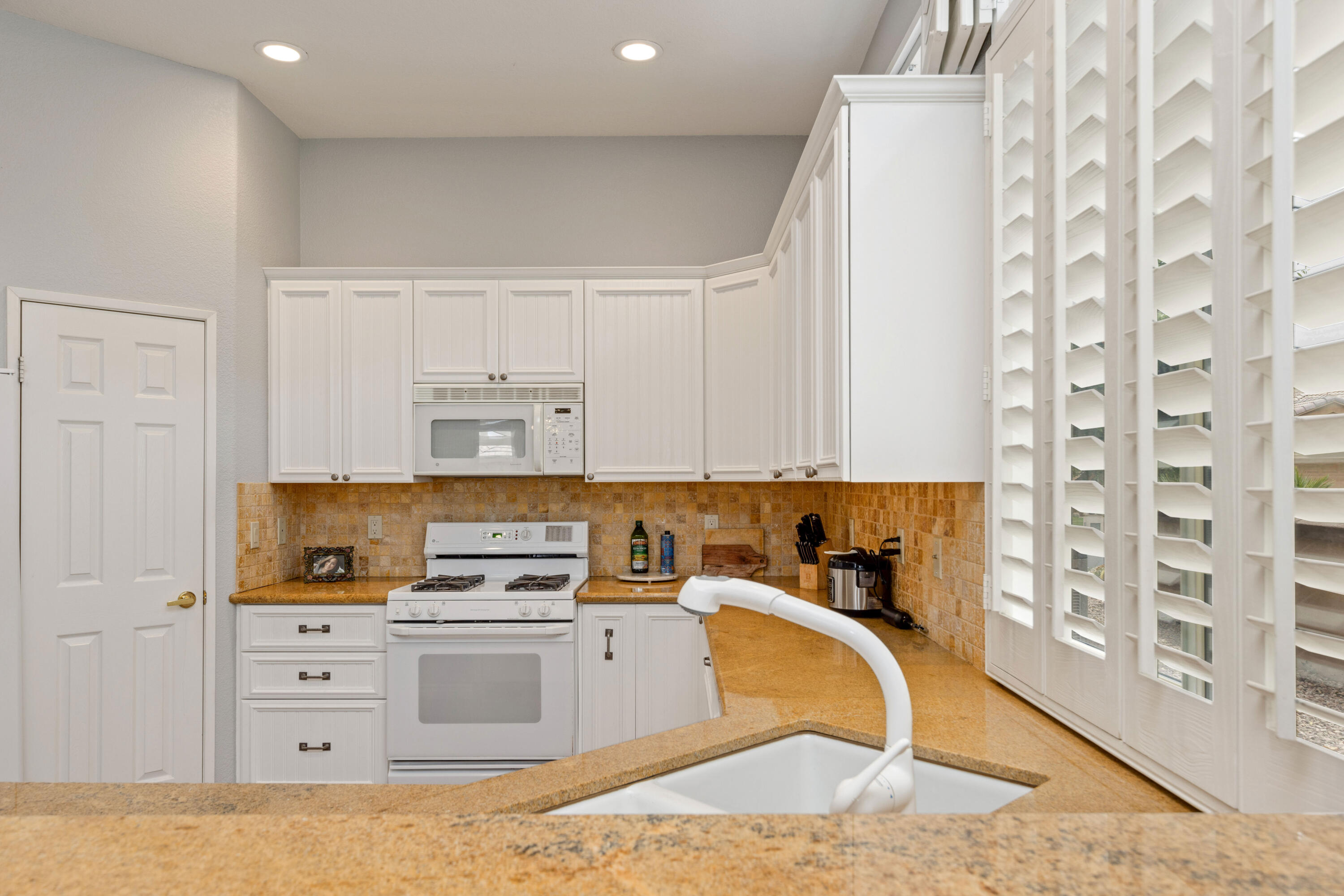 44357 Royal Lytham Drive Indio, CA 92201 - Photo 8 of 21 a kitchen with cabinets appliances and a wooden floor