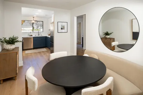 a living room with furniture and a mirror