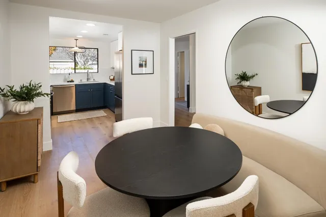 a living room with furniture and a mirror