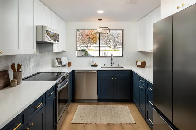 a kitchen with a sink stove and cabinets