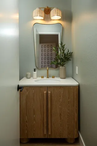 a bathroom with a sink vanity and a mirror