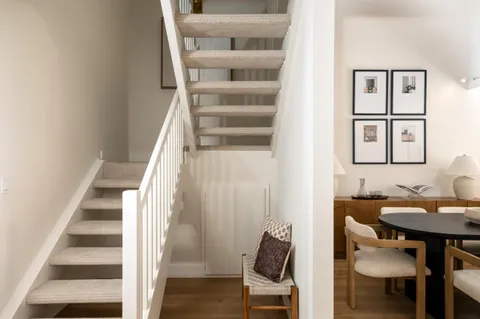 a view of entryway and hall with wooden floor