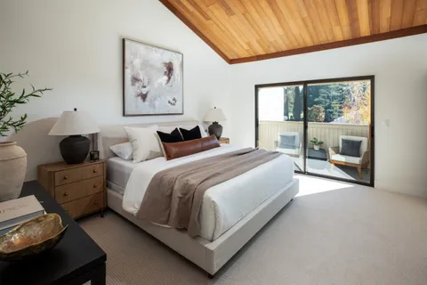 a bedroom with bed and glass door