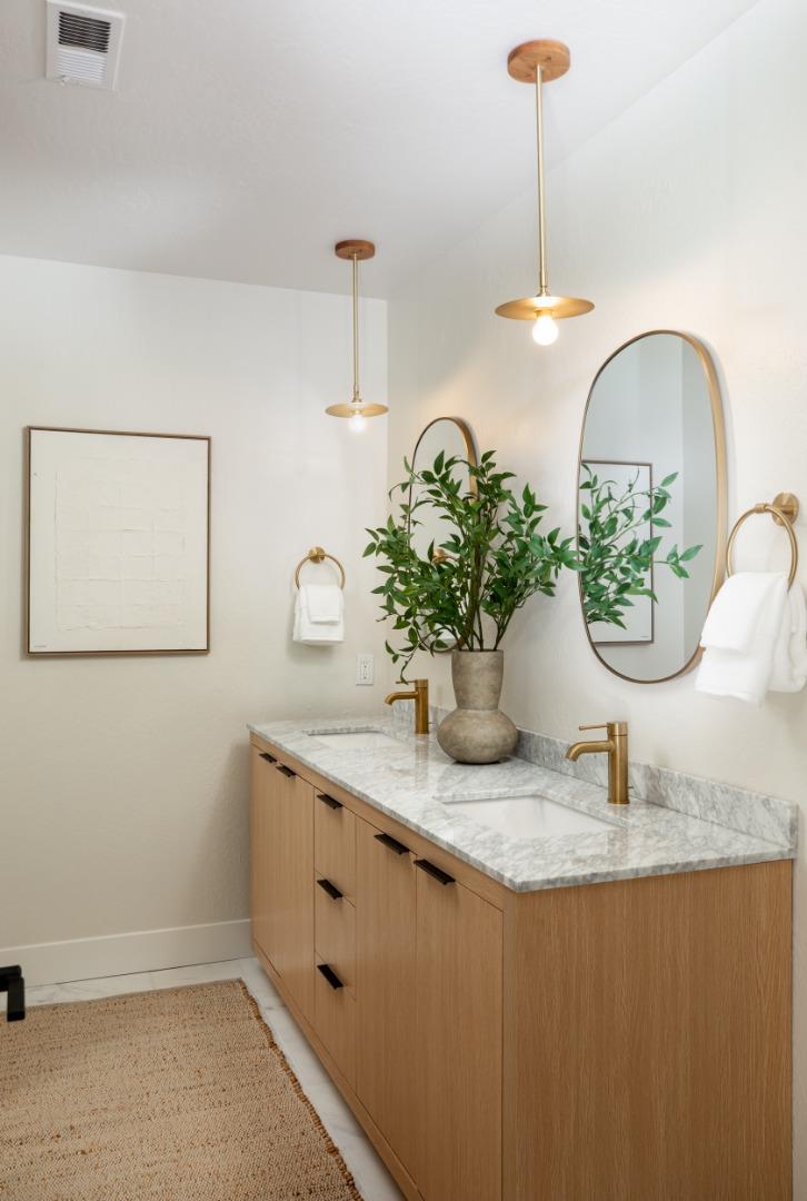 2464 Golf Links Circle Santa Clara, CA 95050 - Photo 26 of 45 a bathroom with a granite countertop sink a potted plant and a window