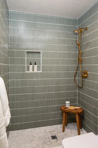 a bathroom with a toilet sink and shower
